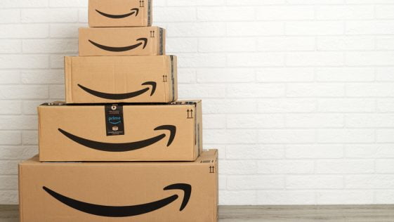 group of Amazon cardboard boxes on white brick wall background