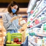 Young,Woman,In,Disposable,Face,Mask,Taking,Dairy,Products,From