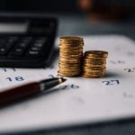 Calendar,,Calculator,And,Stack,Of,Coins,In,A,Office