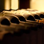 Bottles,Of,Red,Wine,On,A,Wooden,Shelf