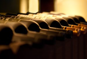 Bottles,Of,Red,Wine,On,A,Wooden,Shelf