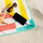 starfish-sunglasses-mobile-phone-kept-beach-blanket