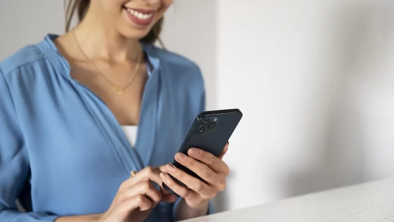 close-up-smiley-woman-holding-smartphone