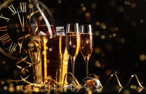 Happy New Year! A golden bucket with champagne, two glasses and a golden serpentine against the background of a clock face.