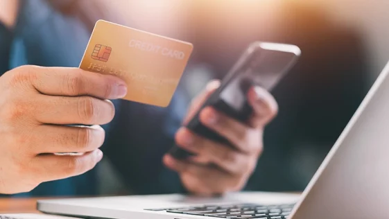 Close up Male hands holding credit card and smartphone, man paying online, credit card shopping, using banking service, entering information, shopping, ordering in internet store, doing secure payment