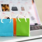 Online shopping or ecommmerce delivery service concept,Paper shopping bag on a laptop computer ,Easy shopping online concept