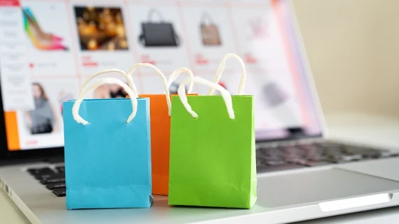 Online shopping or ecommmerce delivery service concept,Paper shopping bag on a laptop computer ,Easy shopping online concept