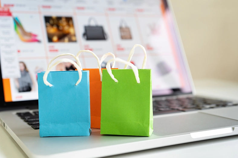 Online shopping or ecommmerce delivery service concept,Paper shopping bag on a laptop computer ,Easy shopping online concept