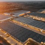 Night aerial view of a warehouse of goods for online stores. Logistic center in the industrial area of the city from above.